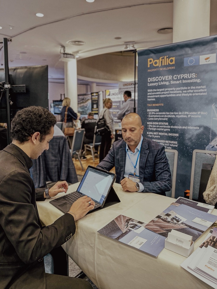 Cravelle representative meeting a Pafilia property developer at an exhibition booth.